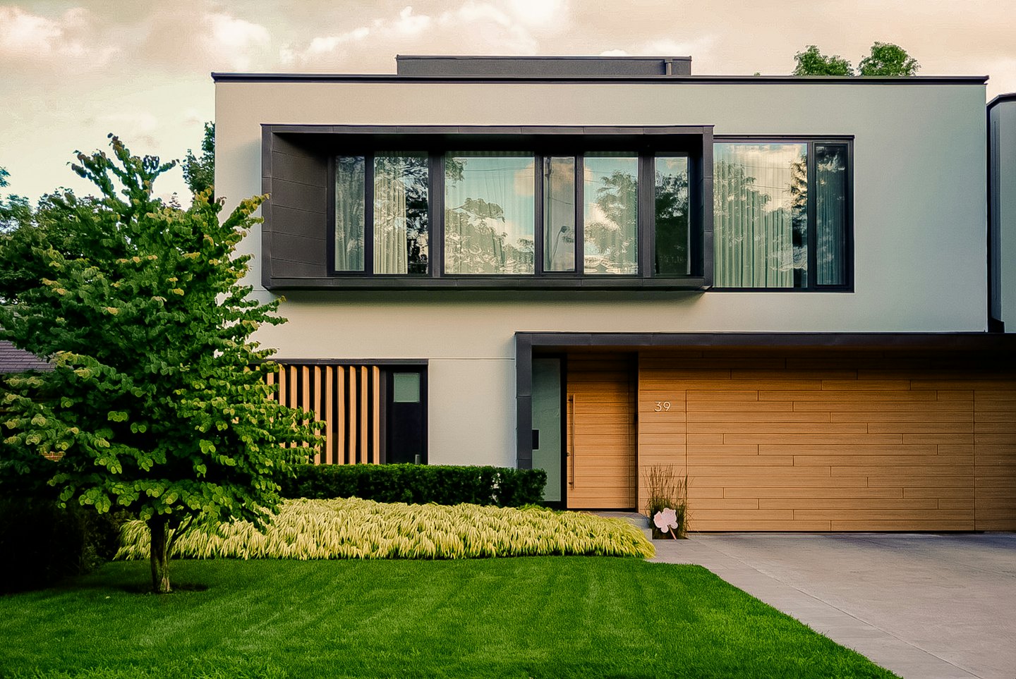 Modern house with stucco facade and wood doors.